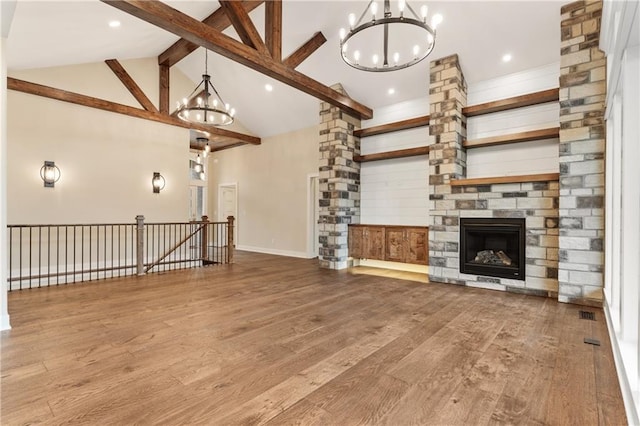 unfurnished living room featuring hardwood / wood-style floors and a notable chandelier