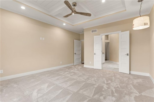 unfurnished bedroom with light colored carpet, beam ceiling, ceiling fan, and a raised ceiling