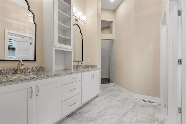 bathroom featuring tile flooring and dual vanity