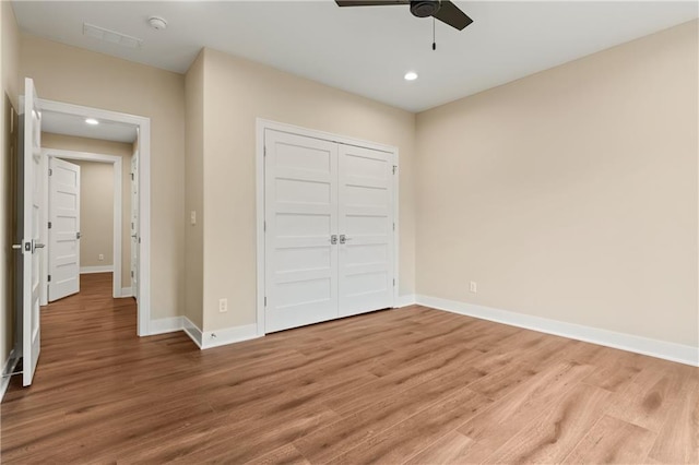 unfurnished bedroom with a closet, ceiling fan, and hardwood / wood-style floors