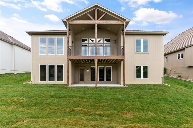 back of house with a patio, a balcony, and a lawn