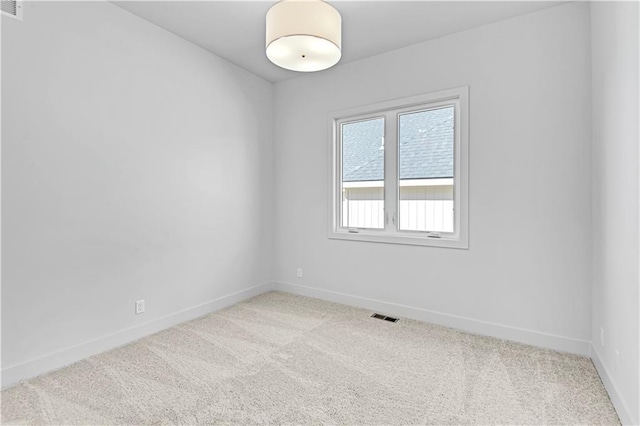 unfurnished room featuring light carpet