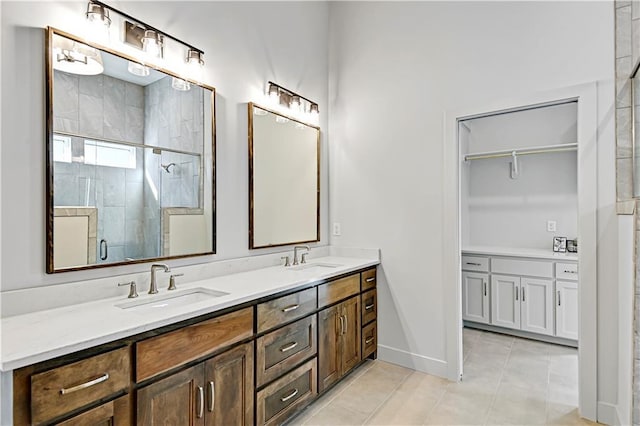 bathroom featuring vanity, tile patterned floors, and walk in shower