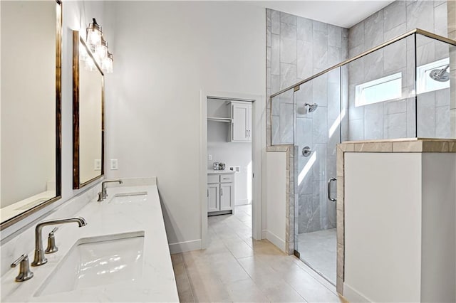 bathroom featuring vanity, an enclosed shower, and tile patterned floors