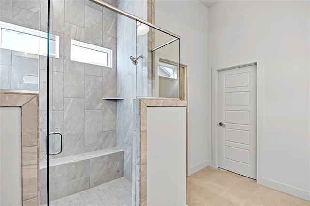 bathroom featuring tile patterned flooring and an enclosed shower