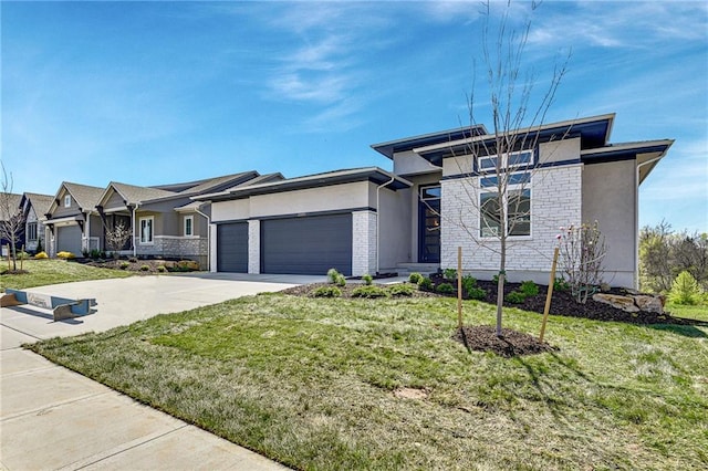 22051 W 100th Ter, Lenexa, KS 66220 - prairie-style house with an attached garage, stucco siding, a front yard, and driveway
