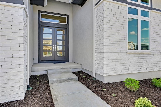 22051 W 100th Ter, Lenexa, KS 66220 - entrance to property featuring french doors, stucco siding, and brick siding