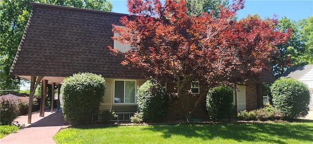 view of property hidden behind natural elements with a front yard