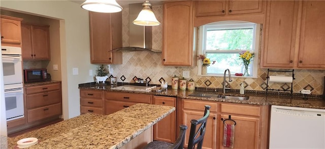 kitchen with black appliances, sink, hanging light fixtures, decorative backsplash, and stone countertops