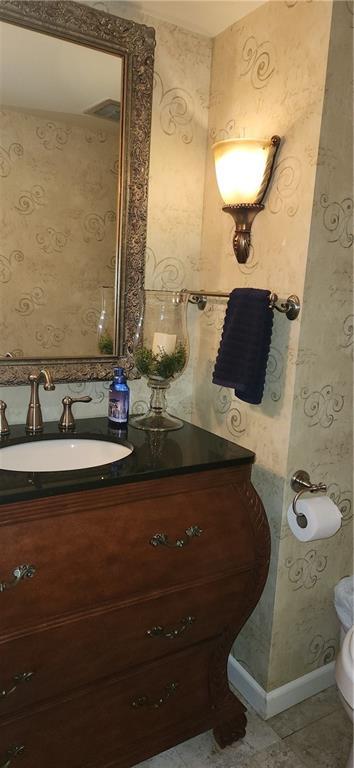 bathroom featuring tile patterned flooring and vanity