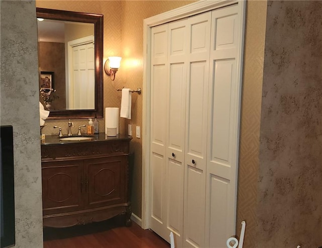 bathroom with hardwood / wood-style floors and vanity