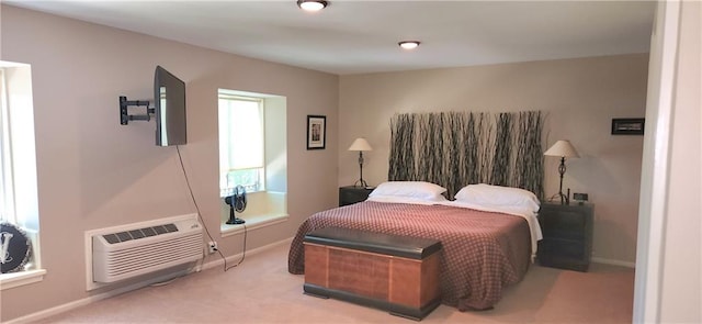 bedroom with a wall unit AC and carpet