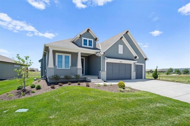 craftsman inspired home featuring a garage and a front lawn