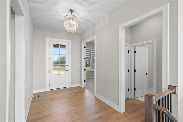 entrance foyer with a notable chandelier and light hardwood / wood-style floors