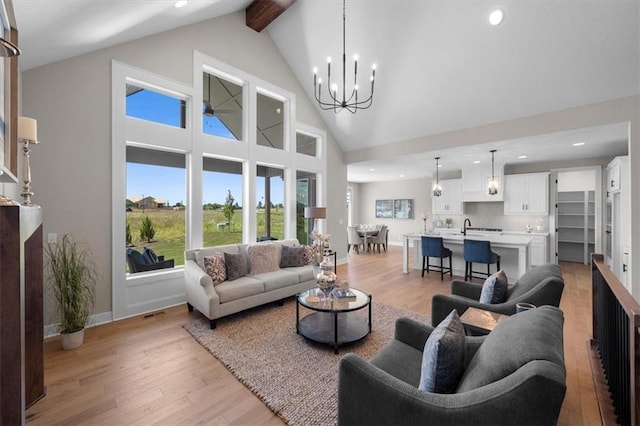 living room featuring an inviting chandelier, high vaulted ceiling, beam ceiling, and light hardwood / wood-style floors