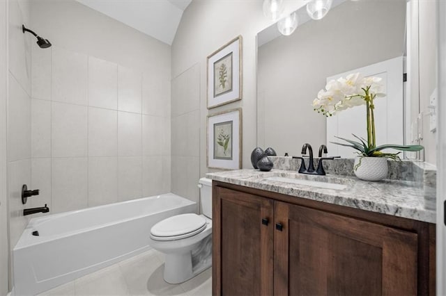 full bathroom featuring vanity, tile patterned flooring, toilet, and tiled shower / bath