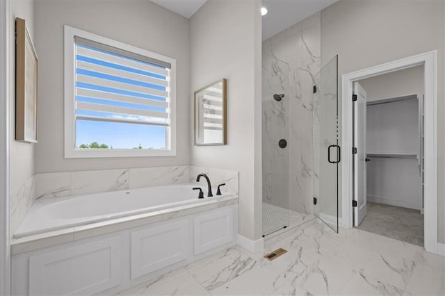 bathroom featuring separate shower and tub