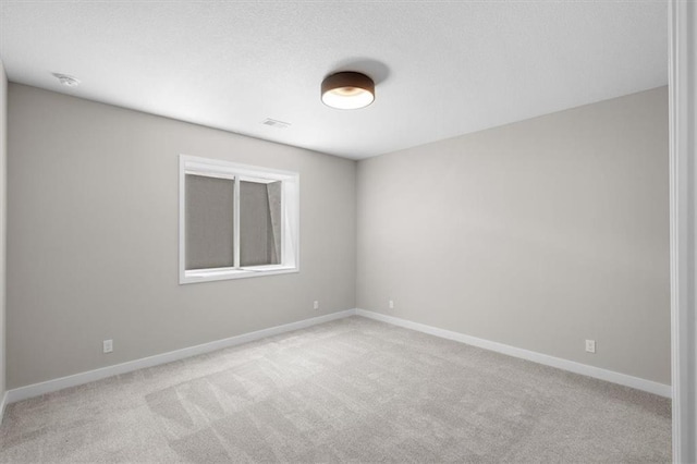 unfurnished room featuring light colored carpet