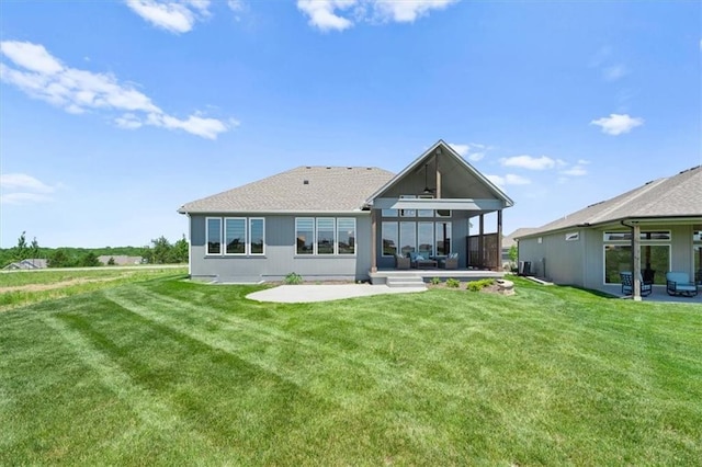 back of property with a patio and a lawn