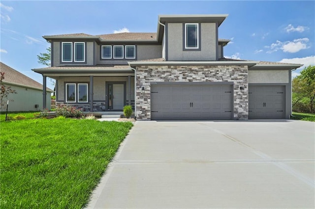 view of front of home with a front yard and a garage