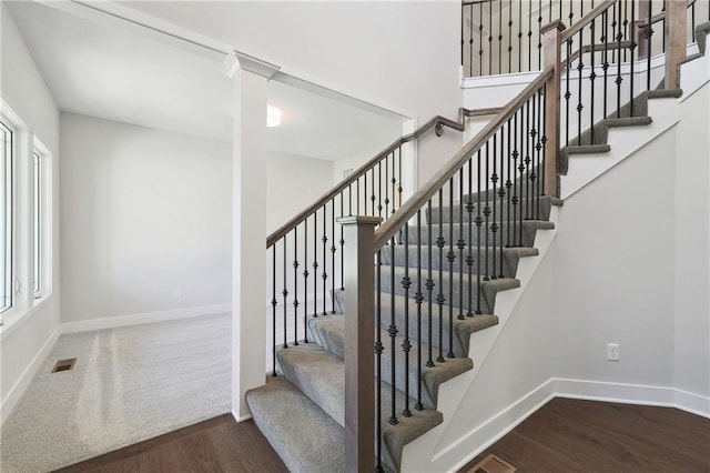 stairs featuring hardwood / wood-style floors