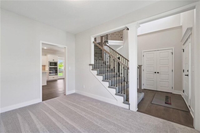 foyer entrance featuring hardwood / wood-style floors and ornate columns