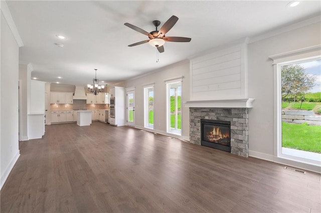 unfurnished living room featuring a wealth of natural light, dark hardwood / wood-style flooring, and a fireplace