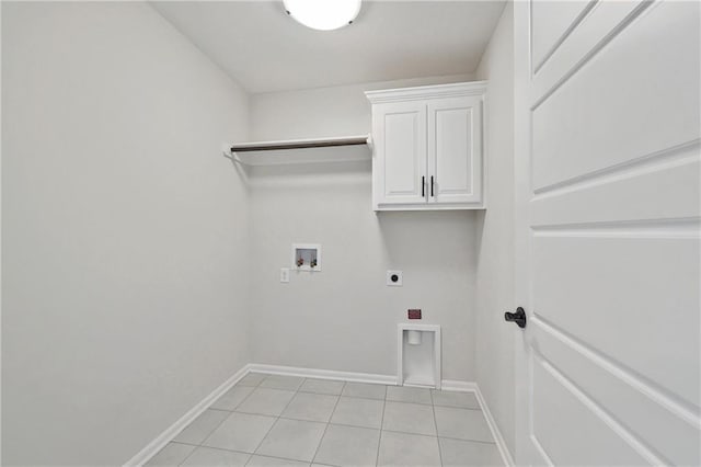 laundry area with light tile patterned flooring, hookup for a washing machine, electric dryer hookup, and cabinets