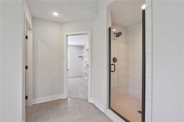 bathroom featuring an enclosed shower and tile patterned floors