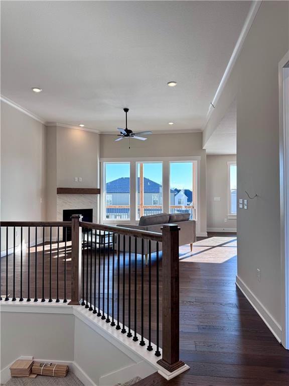 interior space featuring recessed lighting, wood finished floors, baseboards, and ornamental molding