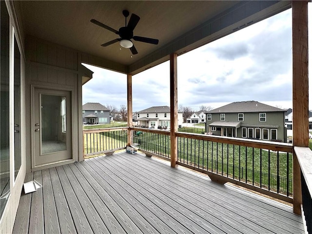 wooden deck featuring ceiling fan and a yard