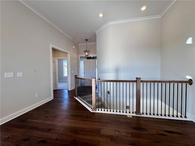 hallway with ornamental molding and dark hardwood / wood-style floors