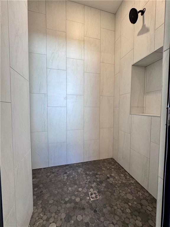 bathroom with a tile shower