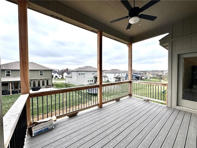 deck featuring a ceiling fan and a residential view