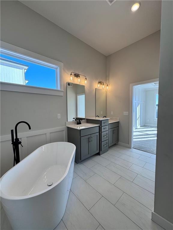 full bathroom featuring a freestanding bath and vanity