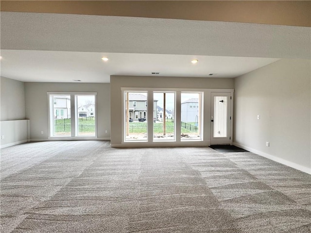 carpeted spare room with recessed lighting and baseboards