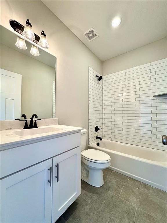 bathroom with visible vents, vanity, toilet, and bathing tub / shower combination