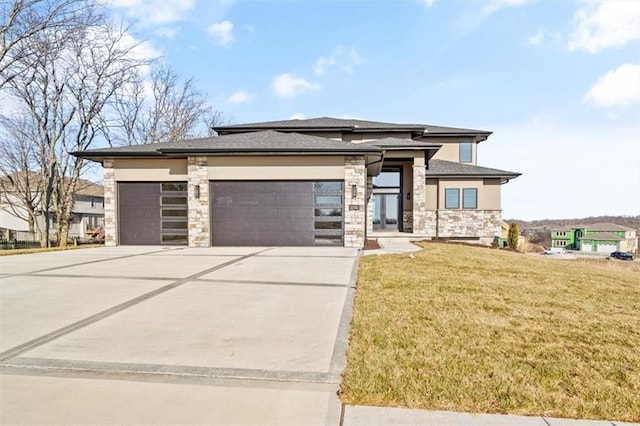 prairie-style house with a front yard and a garage