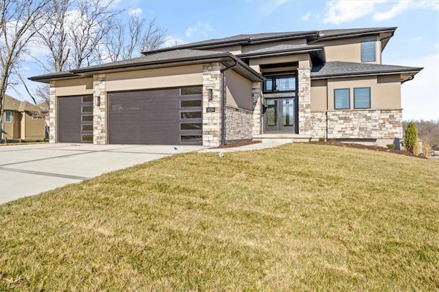 prairie-style home with a front yard, french doors, and a garage