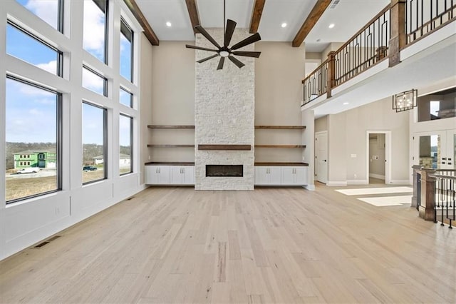 unfurnished living room featuring a towering ceiling and a healthy amount of sunlight