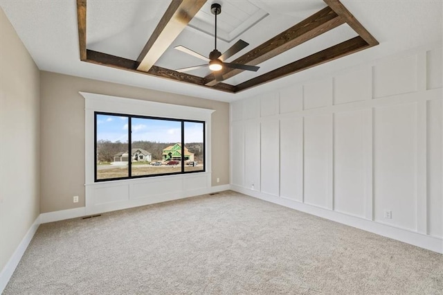 carpeted spare room with beamed ceiling and ceiling fan