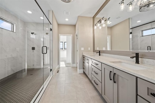 bathroom featuring tile patterned floors, vanity, and walk in shower