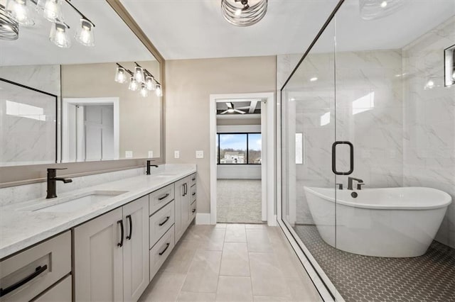 bathroom featuring tile patterned floors, vanity, shower with separate bathtub, and tile walls