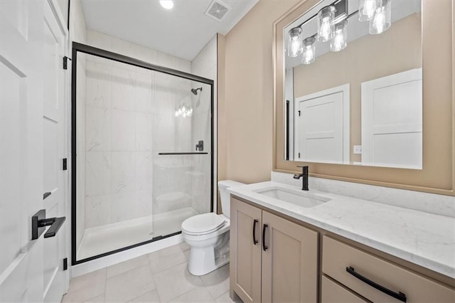 bathroom featuring tile patterned floors, vanity, an enclosed shower, and toilet