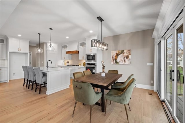 dining room featuring baseboards, visible vents, recessed lighting, and light wood-style floors