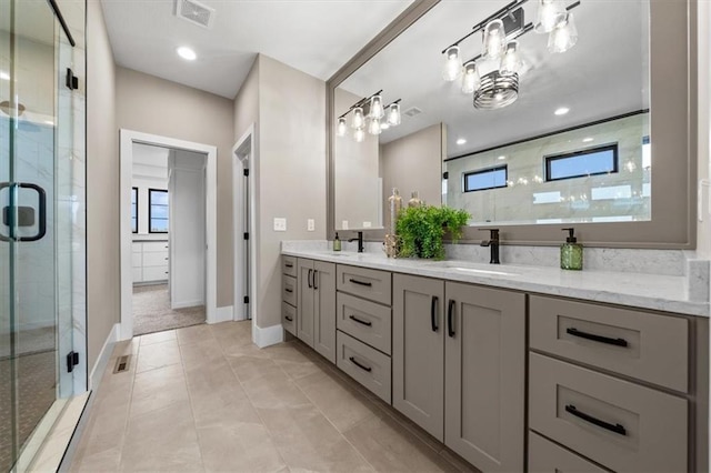full bathroom with visible vents, a sink, double vanity, and a shower stall