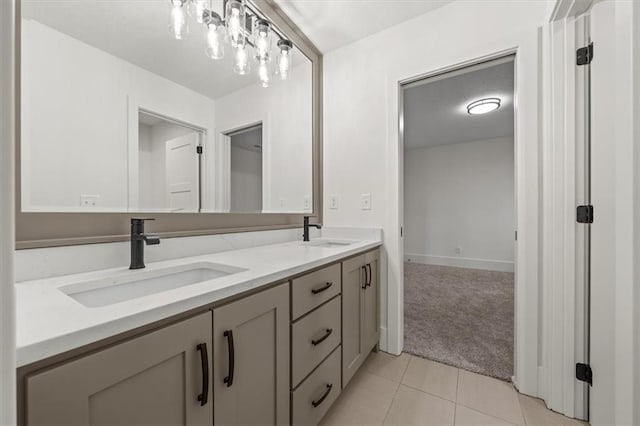 bathroom with tile patterned flooring, a sink, and double vanity