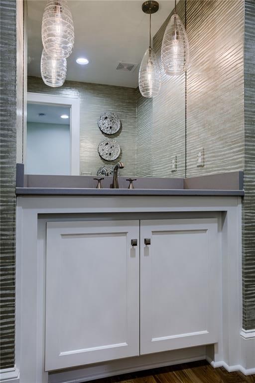 interior details featuring vanity and dark hardwood / wood-style floors