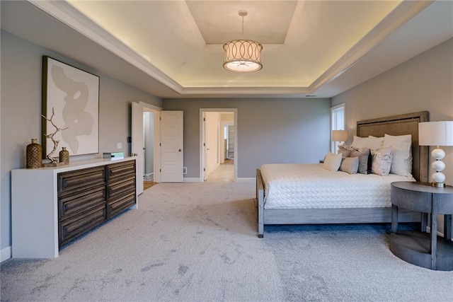 bedroom with a raised ceiling and carpet floors