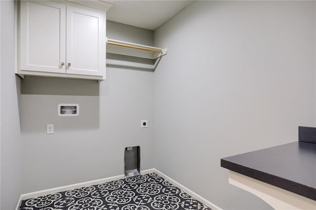 laundry area with electric dryer hookup, tile floors, and cabinets